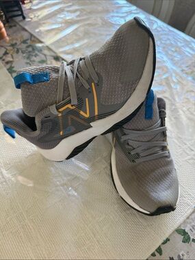 New Balance Gray Athletic Sneakers with Blue and Yellow Accents